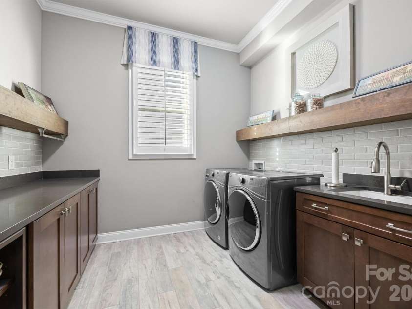 1045 Chippenham Avenue, Lancaster, SC 29720.  MLS# CAR4361759, YatesRealty ID 8794. Laundry room with sink and extra storage.