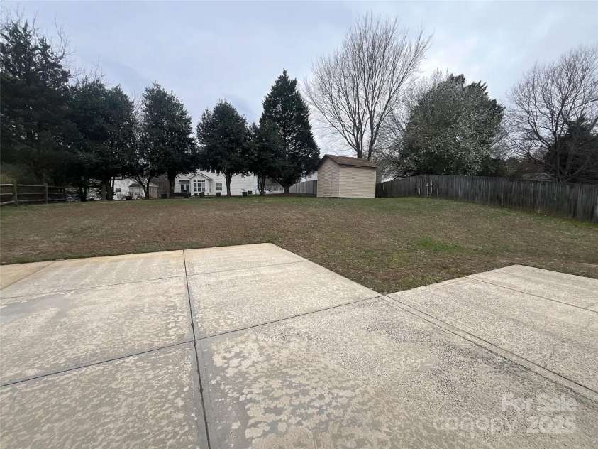 12042 Mallard Ridge Drive, Charlotte, NC 28269.  MLS# CAR4298005, YatesRealty ID 88. Backyard with storage unit