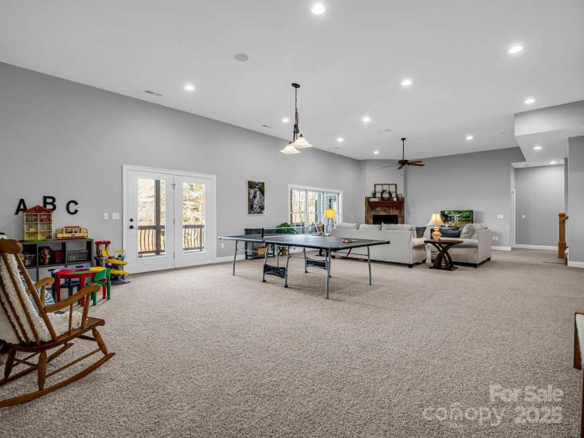 143 Lindsley Court, Hendersonville, NC 28792.  MLS# CAR4211464, YatesRealty ID 8821. Very large flex space with access to lower level deck.