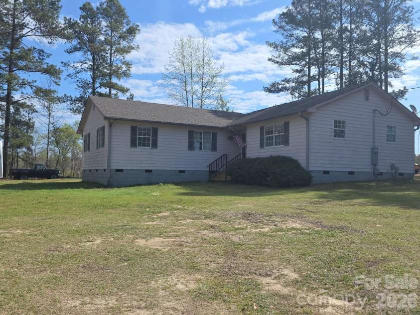 1097 Stadium Road, Pageland, SC 29728.  MLS# CAR4361056, YatesRealty ID 8835. Front/side view from yard