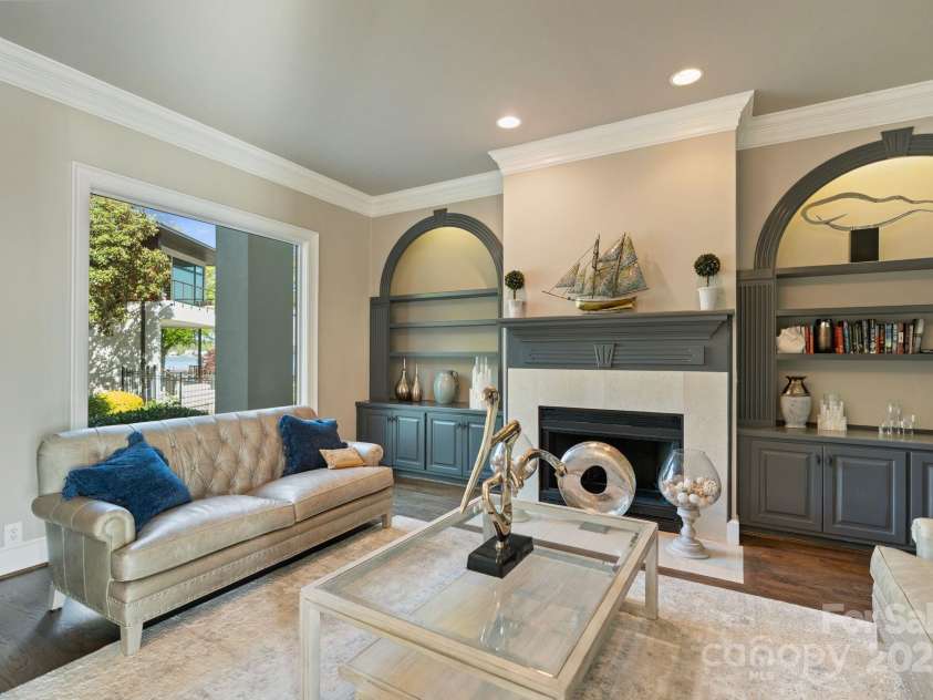114 Ventana Court, Mooresville, NC 28117.  MLS# CAR4241186, YatesRealty ID 8842. Cozy living room with custom built-ins and a fireplace.
