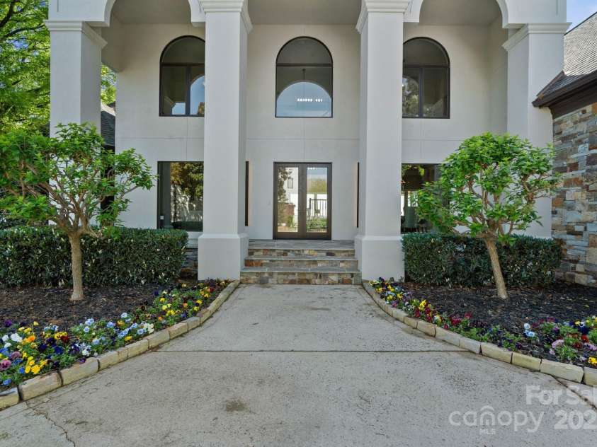 114 Ventana Court, Mooresville, NC 28117.  MLS# CAR4241186, YatesRealty ID 8842. Grand 2-story entrance and covered from porch, surrounded by lush landscaping