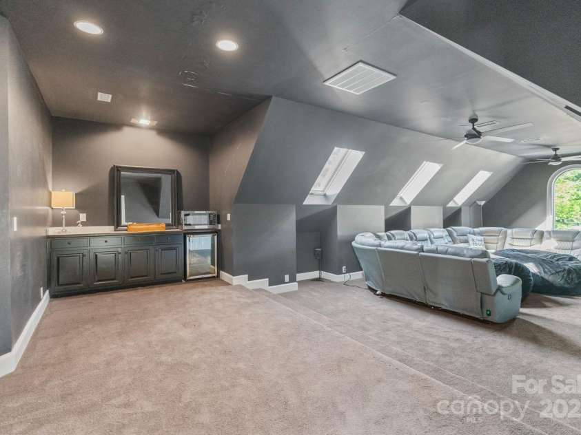 114 Ventana Court, Mooresville, NC 28117.  MLS# CAR4241186, YatesRealty ID 8842. Large media room on upper level with beverage fridge and cabinets for additional storage.