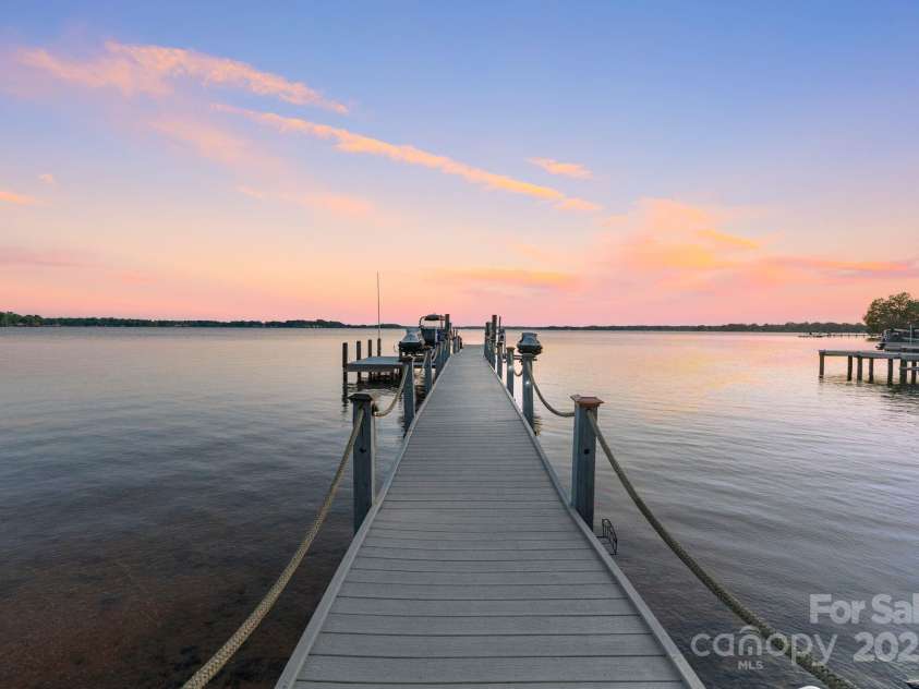 114 Ventana Court, Mooresville, NC 28117.  MLS# CAR4241186, YatesRealty ID 8842. Newer stationary dock with boat and jet-ski lift, plus stairs to swim platform for easy lake access