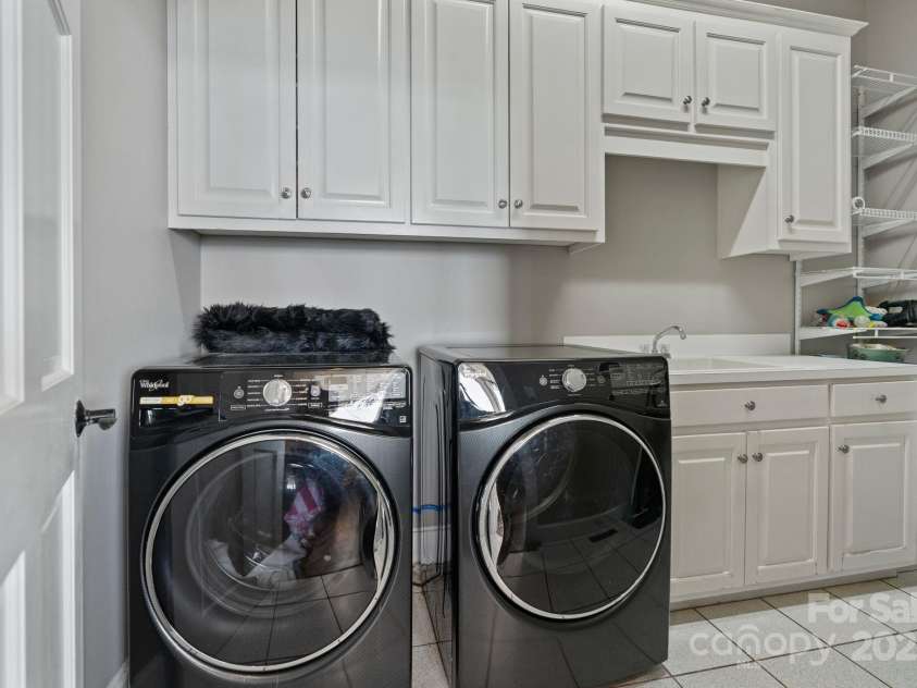 114 Ventana Court, Mooresville, NC 28117.  MLS# CAR4241186, YatesRealty ID 8842. Spacious main level laundry room includes sink, cabinets, and washer and dryer