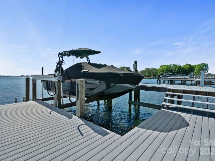 114 Ventana Court, Mooresville, NC 28117.  MLS# CAR4241186, YatesRealty ID 8842. Trex deck with boat lift, plus jet ski lifts.  Boat and skis are negotiable