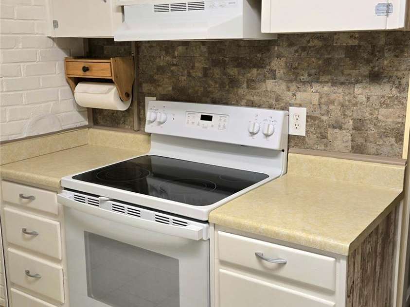 1294 Cane Creek Road, Bakersville, NC 28705.  MLS# CAR4291675, YatesRealty ID 885. Kitchen has nice oven/range and plenty of space for prepping dinner.