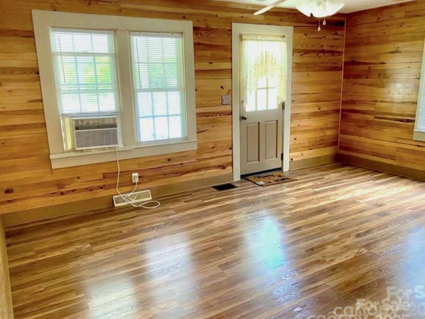 1294 Cane Creek Road, Bakersville, NC 28705.  MLS# CAR4291675, YatesRealty ID 885. Spacious sunny living room offers a great place for company to relax and enjoy the beauty of this home.