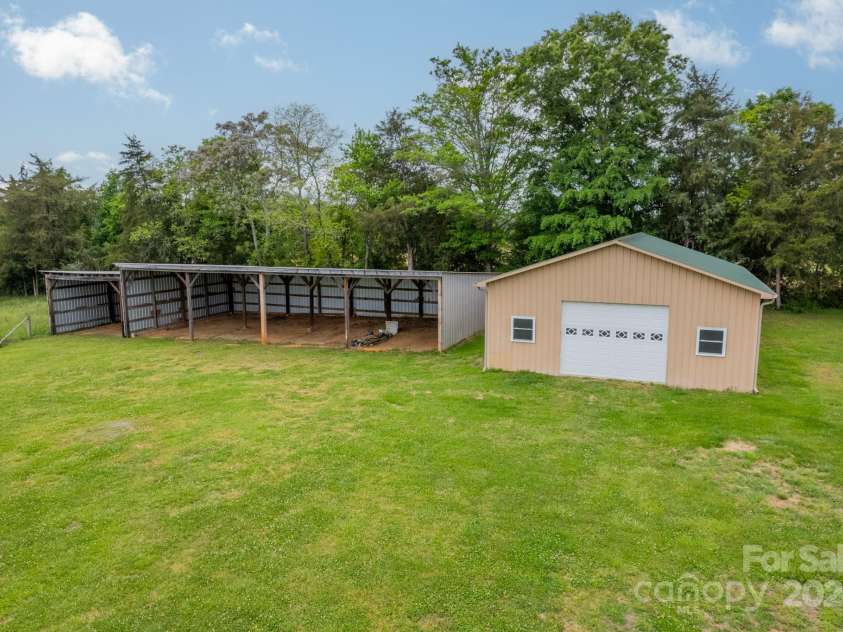 24686 Barbees Grove Road, Oakboro, NC 28129.  MLS# CAR4134946, YatesRealty ID 8851. 30x40 metal building beside the 5-bay tractor and implement shed.