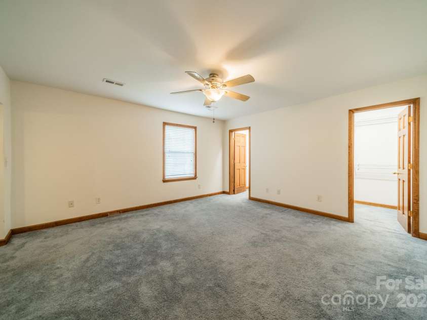 24686 Barbees Grove Road, Oakboro, NC 28129.  MLS# CAR4134946, YatesRealty ID 8851. Primary bedroom with double walk-in closets.