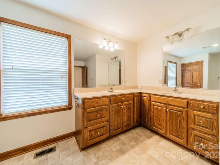 24686 Barbees Grove Road, Oakboro, NC 28129.  MLS# CAR4134946, YatesRealty ID 8851. This very large, full bath is off the hall which leads to the secondary bedrooms and flex room.