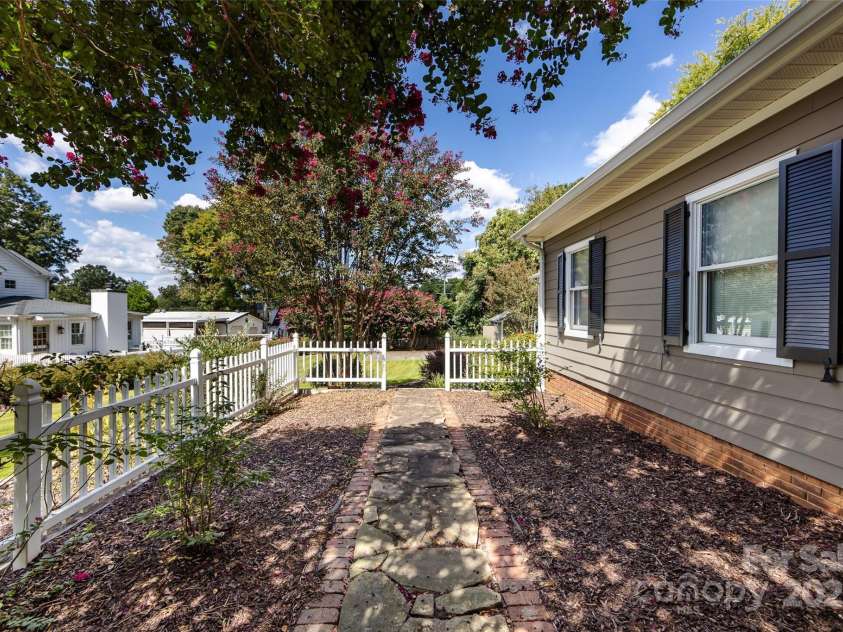 757 Concord Road, Davidson, NC 28036.  MLS# CAR4265019, YatesRealty ID 8872. Well-landscaped side yard with stone walkway leading to the back yard