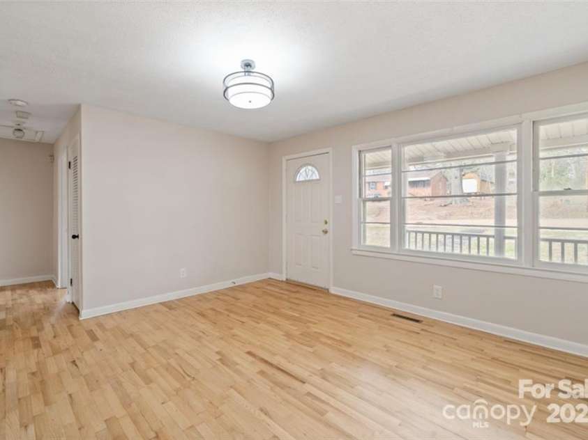 122 Lowry Row, York, SC 29745.  MLS# CAR4214035, YatesRealty ID 8886. Living room with refinished original hardwood flooring - triple windows that will allow alot of natural lighting in
