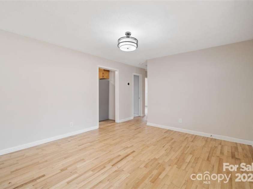122 Lowry Row, York, SC 29745.  MLS# CAR4214035, YatesRealty ID 8886. View from Living Room to the hallway to the bath and two bedrooms with original refinished hardwood flooring