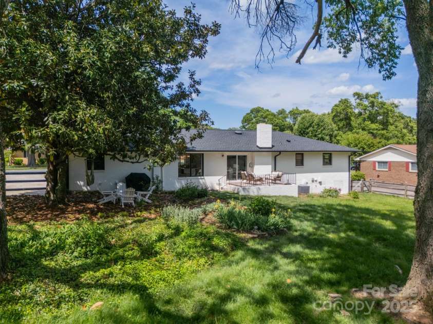 8330 Fallsdale Drive, Charlotte, NC 28214.  MLS# CAR4248517, YatesRealty ID 8896. Backyard Gardens, Sitting area and Back of Home