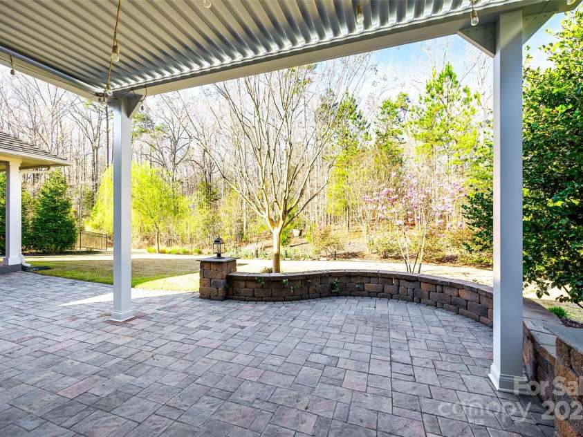 1891 Felts Parkway, Fort Mill, SC 29715.  MLS# CAR4237459, YatesRealty ID 8899. Patio off primary  w/seating wall