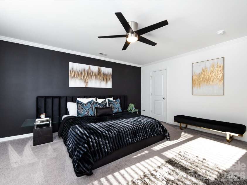 8903 Ansley Park Place, Huntersville, NC 28078.  MLS# CAR4366272, YatesRealty ID 8920. Amble space in this primary suite featuring a striking accent wall, abundant natural light, and plenty of room for a sitting area or retreat.