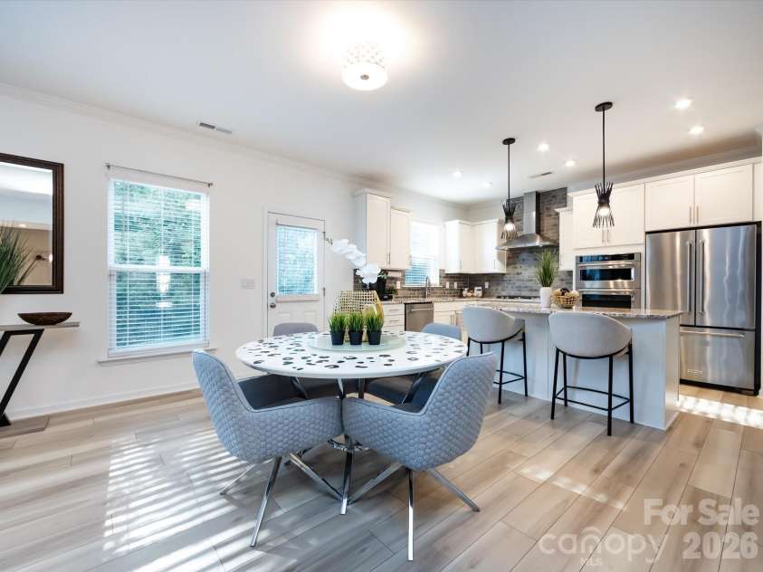 8903 Ansley Park Place, Huntersville, NC 28078.  MLS# CAR4366272, YatesRealty ID 8920. Bright breakfast nook with abundant natural light, open to a modern kitchen featuring an island with seating and stylish finishes.