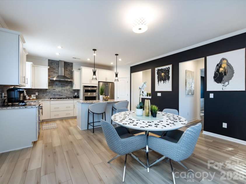 8903 Ansley Park Place, Huntersville, NC 28078.  MLS# CAR4366272, YatesRealty ID 8920. Bright breakfast nook with abundant natural light, open to a modern kitchen featuring an island with seating and stylish finishes.