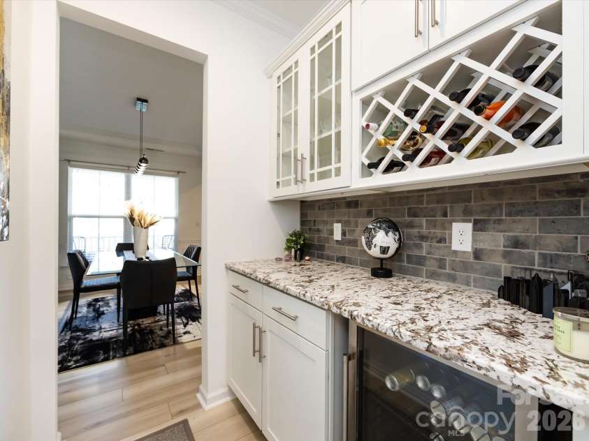 8903 Ansley Park Place, Huntersville, NC 28078.  MLS# CAR4366272, YatesRealty ID 8920. Elegant butler’s pantry with granite countertops, glass-front cabinetry, wine storage, and beverage cooler, perfect for entertaining.
