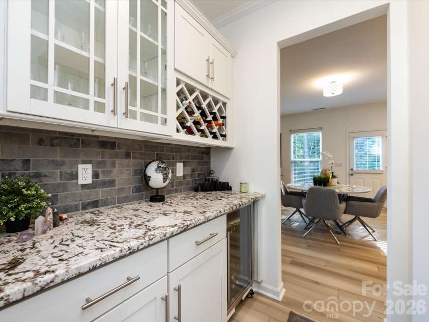 8903 Ansley Park Place, Huntersville, NC 28078.  MLS# CAR4366272, YatesRealty ID 8920. Elegant butler’s pantry with granite countertops, glass-front cabinetry, wine storage, and beverage cooler, perfect for entertaining.