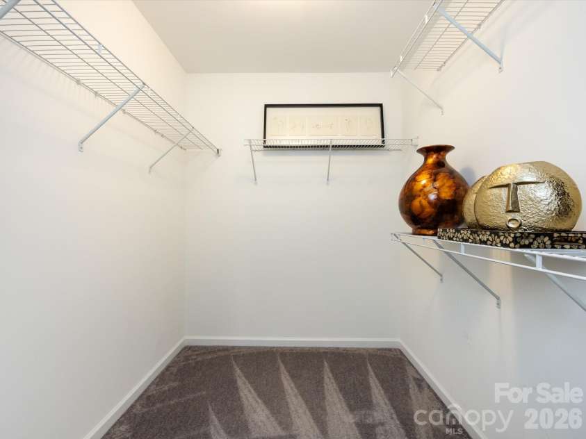 8903 Ansley Park Place, Huntersville, NC 28078.  MLS# CAR4366272, YatesRealty ID 8920. Large walk-in closet in the primary suite offering a space for organized shelving and wardrobe essentials.