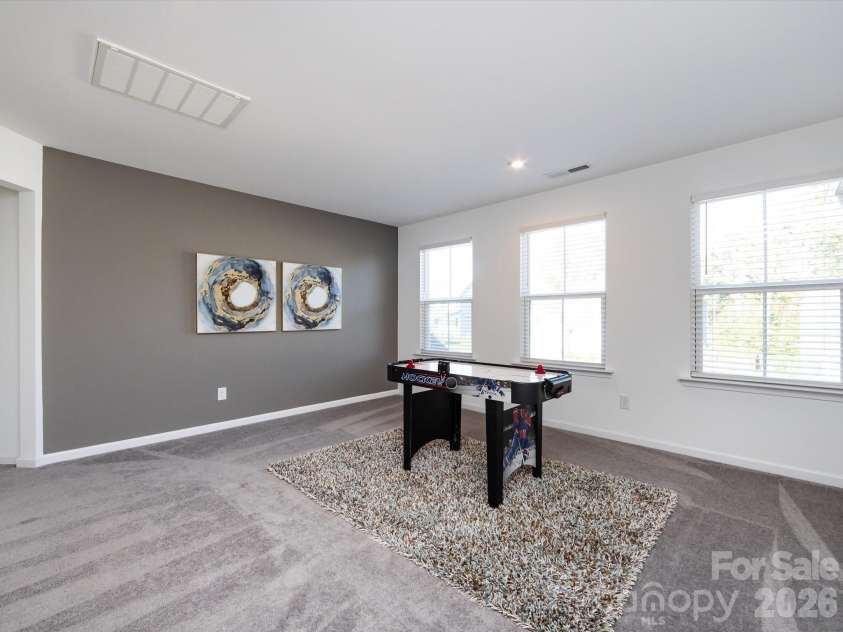 8903 Ansley Park Place, Huntersville, NC 28078.  MLS# CAR4366272, YatesRealty ID 8920. Spacious loft area filled with natural light, perfect for a game room, media space, or additional living area.