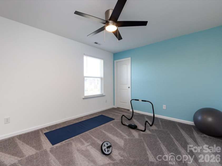 8903 Ansley Park Place, Huntersville, NC 28078.  MLS# CAR4366272, YatesRealty ID 8920. Versatile secondary bedroom with plush carpeting, ceiling fan, and flexible space ideal for guests, a home office, or fitness area.