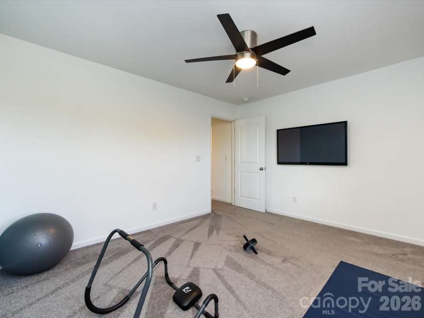 8903 Ansley Park Place, Huntersville, NC 28078.  MLS# CAR4366272, YatesRealty ID 8920. Versatile secondary bedroom with plush carpeting, ceiling fan, and flexible space ideal for guests, a home office, or fitness area.