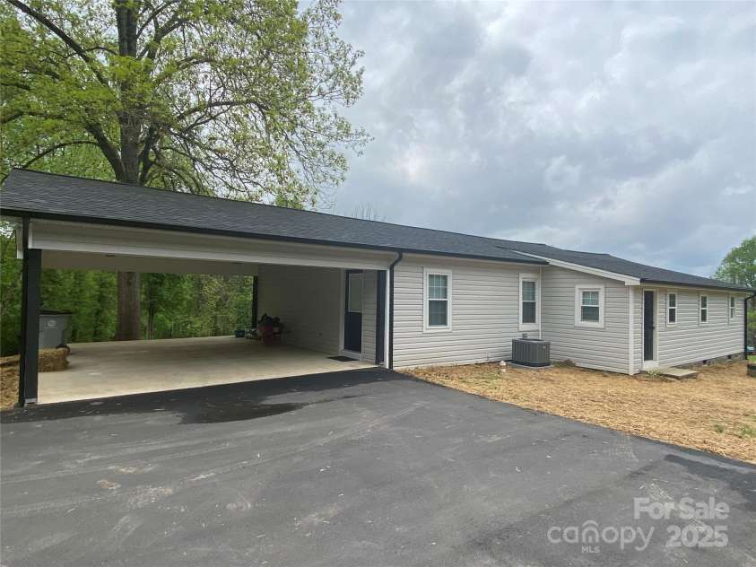1244 Piedmont Drive, Lenoir, NC 28645.  MLS# CAR4250326, YatesRealty ID 8935. Extended driveway from carport