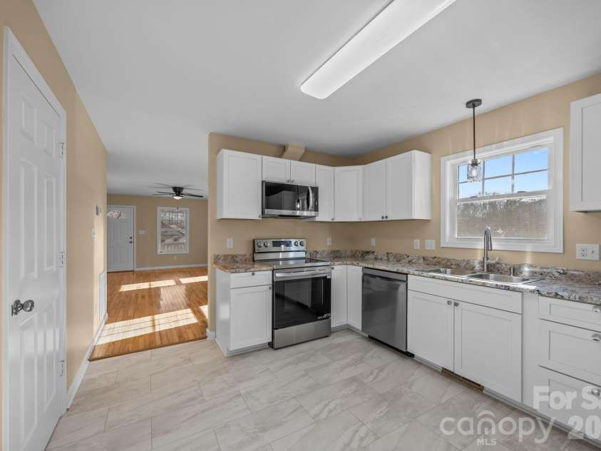 25 Byrd Road, Black Mountain, NC 28711.  MLS# CAR4338401, YatesRealty ID 8959. Kitchen adjoining Dining Area and Living Room