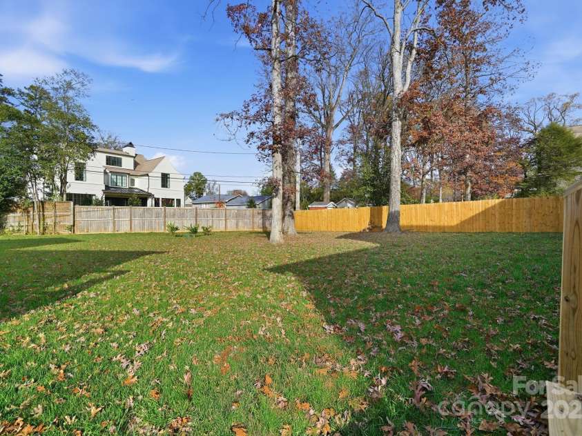 101 Mcalway Road, Charlotte, NC 28211.  MLS# CAR4321405, YatesRealty ID 896. A wide view of the lush tree-lined yard that provides complete privacy.