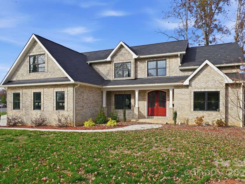 101 Mcalway Road, Charlotte, NC 28211.  MLS# CAR4321405, YatesRealty ID 896. Angled front view showcasing architectural details and expansive front yard.