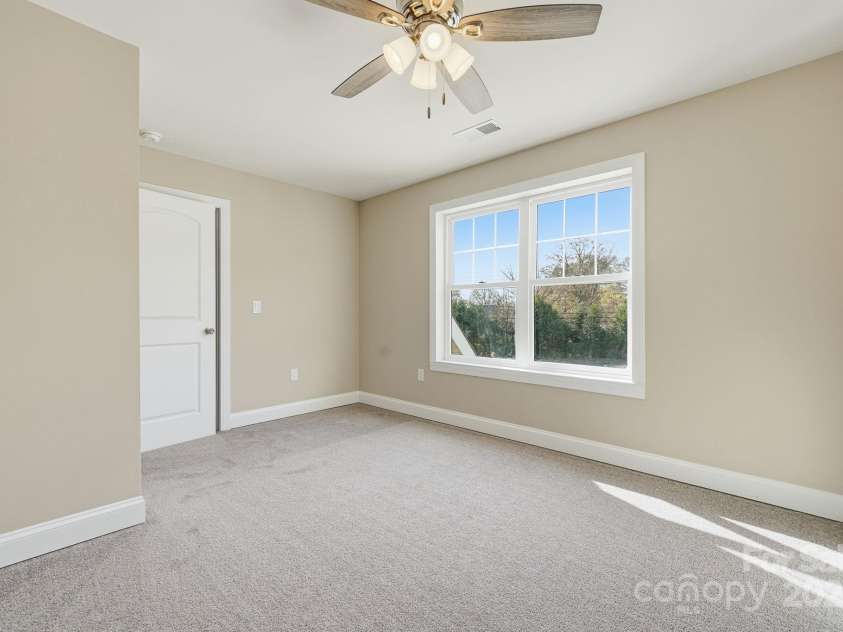 101 Mcalway Road, Charlotte, NC 28211.  MLS# CAR4321405, YatesRealty ID 896. Bright secondary bedroom with large window and plush carpeting.