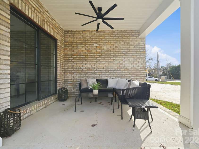 101 Mcalway Road, Charlotte, NC 28211.  MLS# CAR4321405, YatesRealty ID 896. Covered porch seating with modern ceiling fan — the ideal spot for relaxing or entertaining.