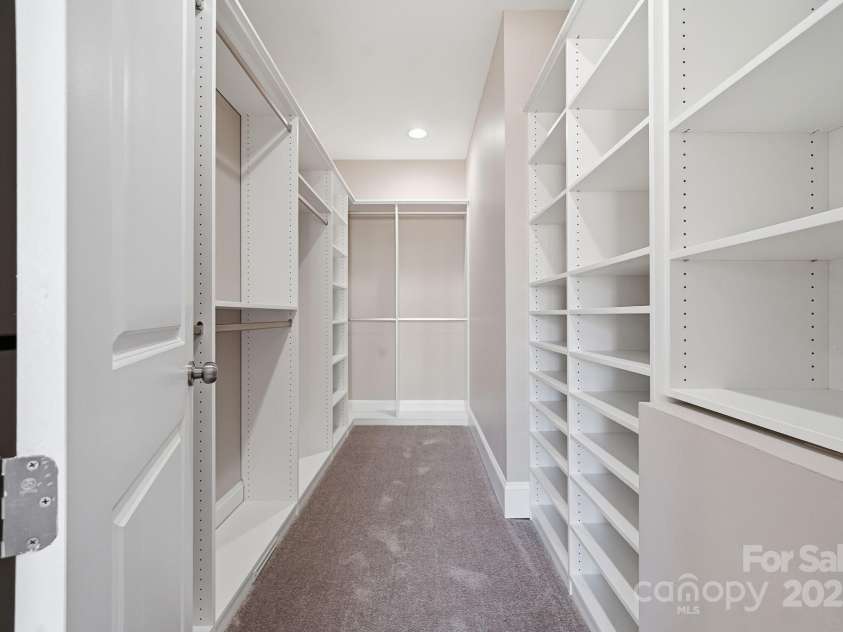 101 Mcalway Road, Charlotte, NC 28211.  MLS# CAR4321405, YatesRealty ID 896.  Expansive custom walk-in closet with built-in shelving and ample storage.