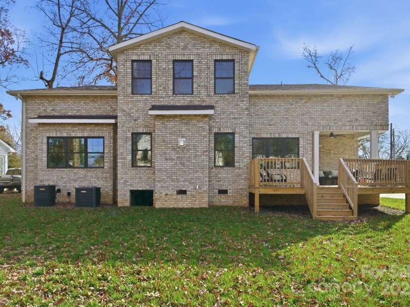 101 Mcalway Road, Charlotte, NC 28211.  MLS# CAR4321405, YatesRealty ID 896. Rear elevation showcasing the expansive backyard – perfect for year-round outdoor living