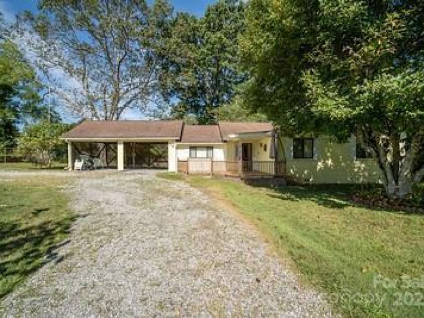 116 Bradshaw Avenue, Hendersonville, NC 28792.  MLS# CAR4179675, YatesRealty ID 8970. Front view with carports