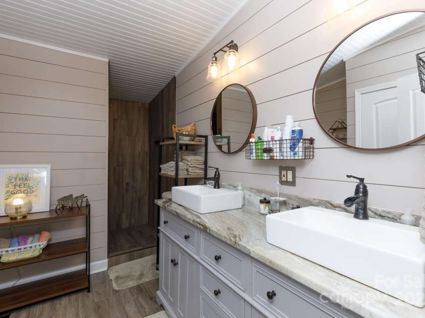 4229 Motocross Trail, Edgemoor, SC 29712.  MLS# CAR4238485, YatesRealty ID 8991. Elegant bathroom retreat with dual sinks and rustic charm—perfect for a spa-like experience.