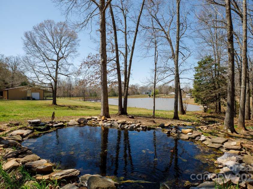 4229 Motocross Trail, Edgemoor, SC 29712.  MLS# CAR4238485, YatesRealty ID 8991. Serene pond view with rustic charm—your private paradise awaits! Perfect for weddings and relaxation.