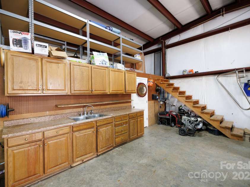 4229 Motocross Trail, Edgemoor, SC 29712.  MLS# CAR4238485, YatesRealty ID 8991. Spacious workshop with ample storage and utility sink—perfect for your next big project!