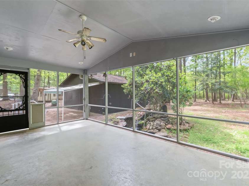 111 Pine Grove Church Road, Concord, NC 28025.  MLS# CAR4245554, YatesRealty ID 9001. Oversized screened-in porch overlooking your private wooded view and koi pond