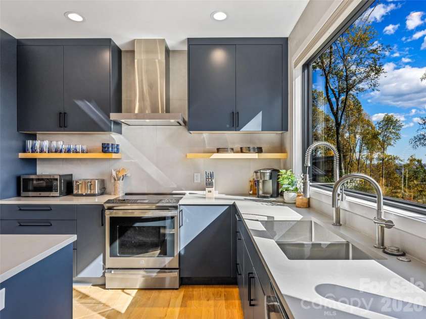 15 Laurel Ledge Way, Fletcher, NC 28732.  MLS# CAR4316029, YatesRealty ID 9014. Modern cabinets, open shelving, and exquisite counters abound!