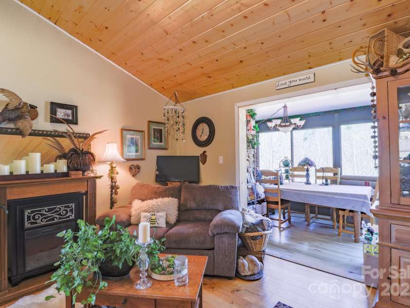 146 Green Briar Lane, Green Mountain, NC 28740.  MLS# CAR4287422, YatesRealty ID 9017. Upper Living into Sunroom/Dining