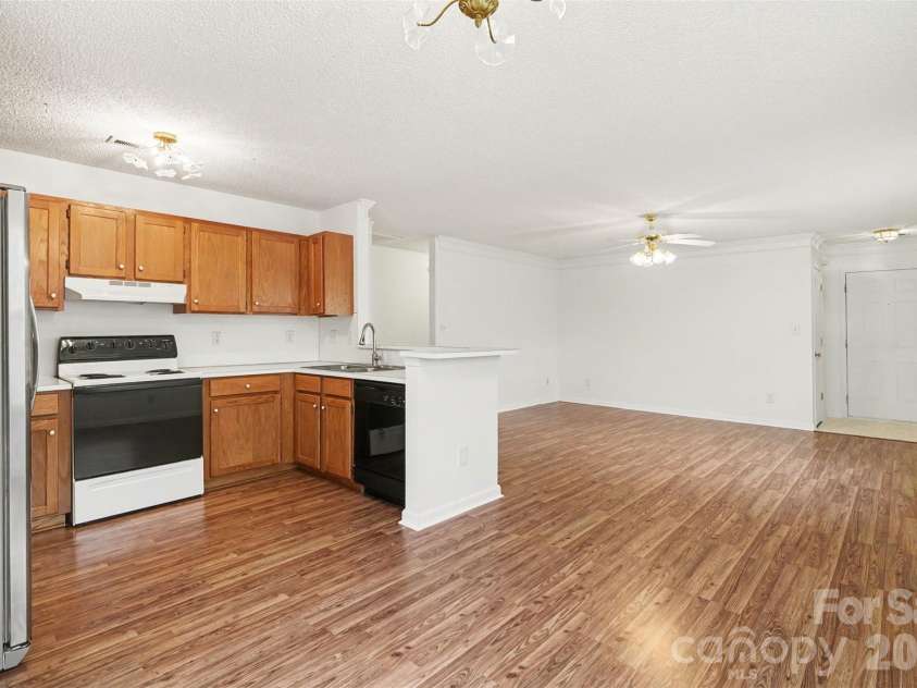 205 Amir Circle, Matthews, NC 28105.  MLS# CAR4356805, YatesRealty ID 9020. Kitchen to Living Room 