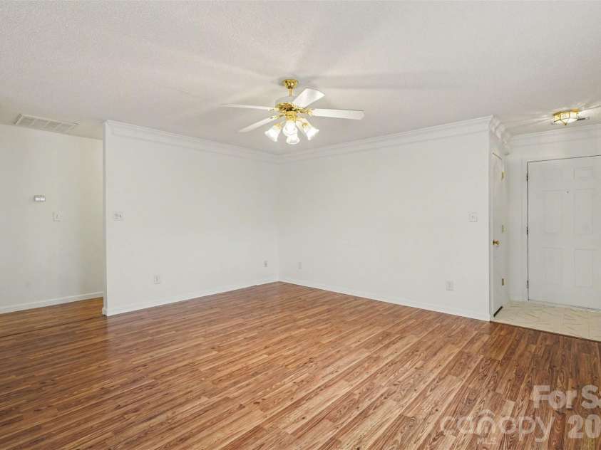 205 Amir Circle, Matthews, NC 28105.  MLS# CAR4356805, YatesRealty ID 9020. Living Room facing hallway and front door.