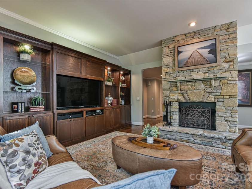 409 North Fork Road, Black Mountain, NC 28711.  MLS# CAR4284708, YatesRealty ID 904. Custom built ins make for a handsome entertainment center that does not detract from the fireplace. 