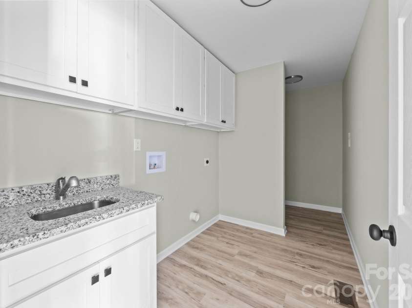 1700 Bringle Ferry Road, Salisbury, NC 28146.  MLS# CAR4342002, YatesRealty ID 9043. Laundry room with utility sink and cabinetry/storage space