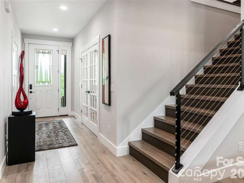 99 Timber Ridge Circle, Leicester, NC 28748.  MLS# CAR4364213, YatesRealty ID 9071. Inviting entrance, warm & contemporary stairs with cable railings