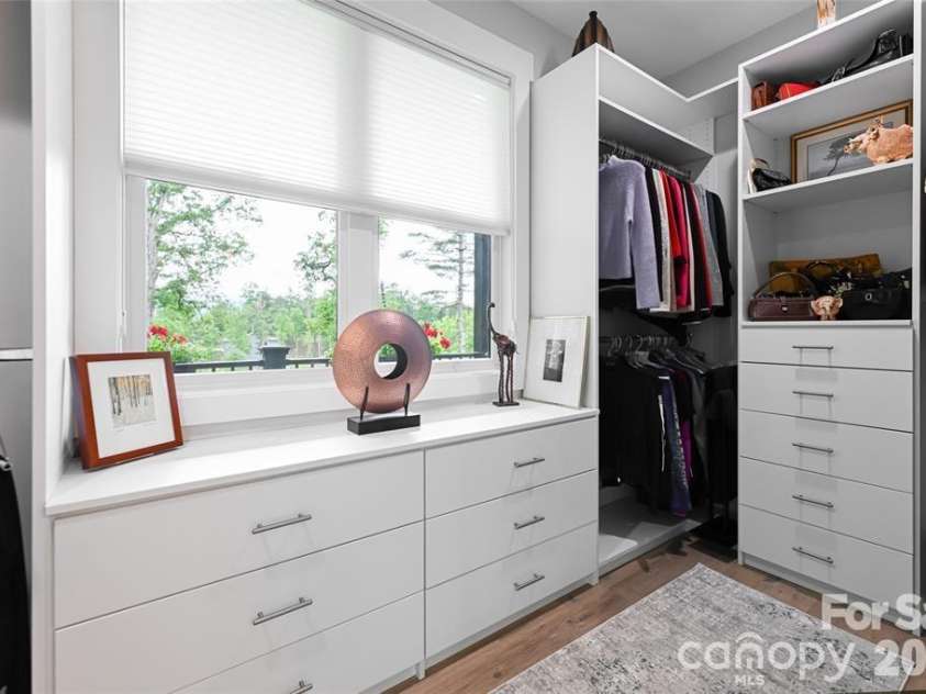 99 Timber Ridge Circle, Leicester, NC 28748.  MLS# CAR4364213, YatesRealty ID 9071. Primary Bedroom Closet with natural light and custom designed use of space.
